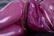 Sophie in an shiny transparent purple PVC suit tied and gagged in bed (Pics)
