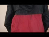 Enni dresses herself in shiny nylon shorts and rain cloths (Video)