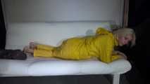 Watching Pia preparing her sofa with a shiny nylon cloth wearing a yellow shiny nylon rainsuit enjoying herslef on the sofa (Video)