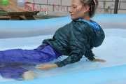 Watching Sandra wearing a sexy blue shiny nylon rainwear bib and a green down jacket while taking a sunbath and a bath in the swimming pool  (Pics)