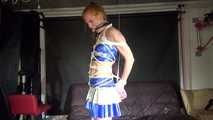 Red haired Woman bound and gagged in a shiny wetlook Cheerleader Dress