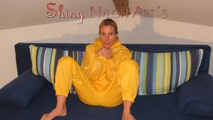 Sexy blonde archive girl posing and lolling on a sofa wearing sexy yellow rainwear over nothing (Pics)