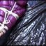 Mara tied and gagged on bed wearing s shiny purple down jacket and blue rain pants (Video)