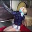 Pia kneeling tied and gagged overhead with a monoglove wearing a sexy white shiny nylon shorts and a blue rain jacket (Video)