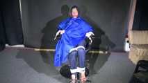 Watching Sonja sitting on a hairdresser`s chair wearing sexy blue shiny nylon rainwear with a raincape being tied, gagged and hooded with ropes and a clothgag (Video)