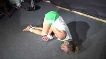 Sexy Sandra being tied and gagged on the floor wearing a sexy green shiny nylon shorts and a white top (Video)