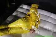 Get Pictures of Pia bound and gagged in her yellow shiny nylon Rainwear