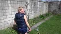 Sexy Sandra wearing a sexy darkblue shiny nylon shorts and a blue downvest during her gardening work (Video)