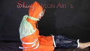 Watching ***Sonja*** wearing a sexy black shiny nylon rain pants and an orange rainjacket being tied, gagged and hooded with belts and a clothgag (Pics)