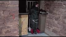 Jill tied and gagged on bars wearing a shiny nylon rain combination and rubber boots (Video)