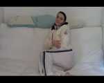 Jill enjoying herself on a sofa wearing white shiny nylon rain pants and a white down jacket (Video)