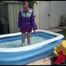 Watching Mara wearing a supersexy purple down skirt and a purple down jacket cleaning the swimming pool and playing with water (Video)