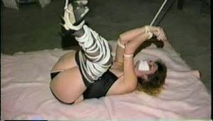 31 Yr OLD SEXY SUSIE IS TIED UP IN HER BASEMENT, TAPE GAGGED, CROTCH ROPED & FEET ,LEGS, ARMS & HANDS TIED UP IN THE AIR THEN MOUTH STUFFED CLEAVE GAGGED WITH AN ACE BANDAGE, TIT TIED & TIGHTLY TIED TO A CHAIR  (D55-1)