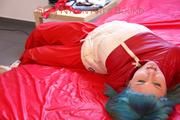 Mara tied, gagged and hooded on bed wearing a shiny red old school down jacket and pants (Pics)