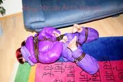 Jill tied and gagged with webbing load restraint assembly on the floor wearing a sexy purple down jacket and a rain pants (Pics)