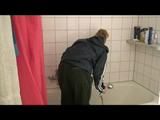 Jenny taking a shower in her flat wearing sexy shiny nylon rainwear (Video)