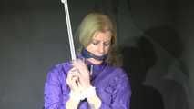 Watching sexy Pia wearing a sexy lightblue shiny nylon shorts and a purple rain jacket being tied and gagged with ropes and a ball gag overhead (Video)