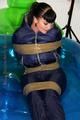 Jill tied and gagged in a shiny nylon down jacket 