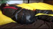 Lucy wearing a sexy black/red shiny nylon downsuit preparing her bed with nylon linen and enjoys it (Video)