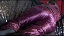 Watching Lucy preparing her sofa with a black shiny nylon cloth for lolling with a sexy purple downsuit on the sofa (Video)