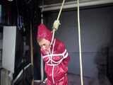 Watch Sandra bound gagged and noosed wearing her shiny nylon Rainwear