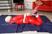 Nina tied and gagged in a shiny red PVC suit