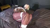 Watching sexy Sonja being tied and gagged on a bed with ropes and a clothgag wearing a supersexy shiny brown nylon pants and a brown rain jacket (Video)