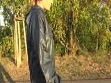 Get a Video with Sandra walking in her shiny nylon Rainsuit at a very hot and sunny day