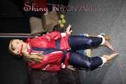Sexy Sandra wearing sexy red/blue rainwear being tied and gagged with ropes and a clothgag on a chair (Pics)