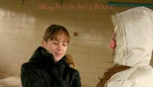 Blond-haired archive girl tied and gagged by another archive girl wearing shiny down jackets (Pics)