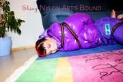 Jill tied and gagged with webbing load restraint assembly on the floor wearing a sexy purple down jacket and a rain pants (Pics)