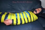 Katharina taped and gagged in a blue nylon rainsuit