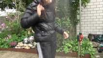 Watching Aiyana wearing a sexy black shiny nylon rainpant and a black shiny nylon down jacket trying the garden shower  (Video)