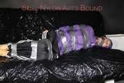 Sexy Sandra tied and gagged with tape and a cloth gag on a sofa wearing sexy downwear (Pics)