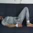 Katharina tied and gagged on a sofa wearing a shiny grey nylon catsuit (Video)