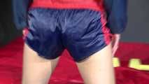 Watching sexy Sonja wearing a blue/red shiny nylon shorts and blue/red rain jacket during her workout with dumbbells (Video)