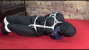 Jill tied, gagged and hooded lying on the floor wearing sexy shiny nylon black rainwear (Video)