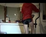 Sonja wearing a darkblue shiny nylon shorts size 3 and a red shiny nylon rain jacket during her workout on the crosstrainer (Video)