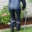 Watch Chloe enjoying her shiny nylon Rainwear doing some watering in the garden