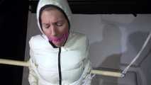 Sexy Sandra tied, gagged and hooded with ropes, a bar  and a ballgag wearing a supershiny rose shiny nylon pants and a white special down jacket (Video)