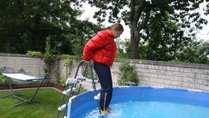 Watch Sandra taking a bath at a hot Summer Day with her shiny nylon Downjacket using the Jacket as a snorkel (special wish for a friend)