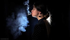 Irina is smoking 100mm cigarette in the dark room