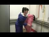 04:20 Min. video with Simone tied and gagged by Jill in shiny nylon rainwear