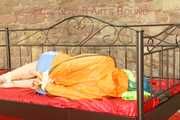 Mara tied and gagged on a princess bed in an old cellar wearing an supersexy shiny lightblue nylon shorts and an orange rain jacket (Pics)