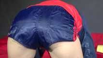 Watching sexy Sonja wearing a blue/red shiny nylon shorts and blue/red rain jacket during her workout with dumbbells (Video)