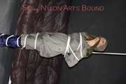 Sexy Sandra being tied and gagged overhead with ropes and a clothgag hodded wearing a sexy rainwear combination (Pics)