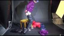 Mara wearing sexy purple rainwear trying on a black down pants and a red down jacket infront of the camera (Video)