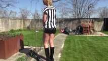 Watching Pia sweeping the terrace wearing a sexy black shiny nylon shorts, a striped top and black rubber boots (Video)