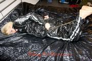 Pia tied and gagged on bed wearing a shiny black PVC sauna suit (Pics)