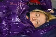 Sonja tied and gagged on bed with cuffs wearing a sexy lightblue rain pants and a purple down jacket (Pics)